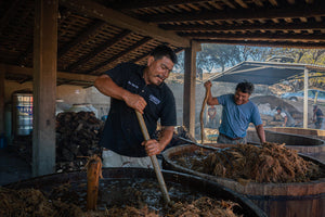 Stirring the fermenting agaves